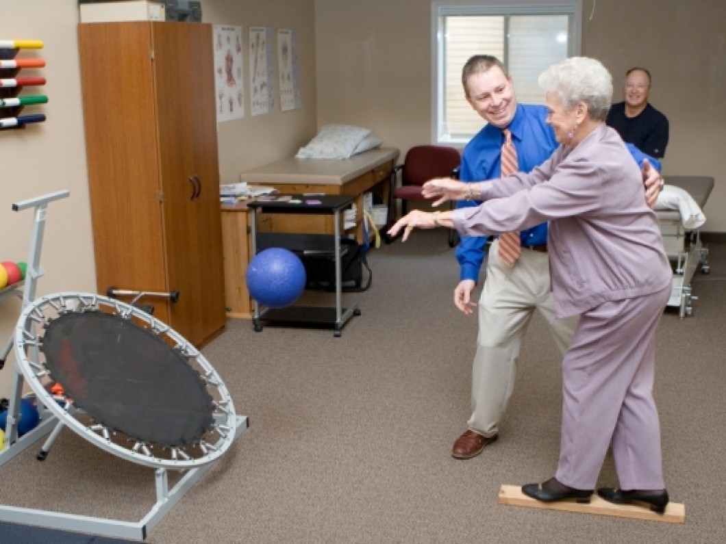 Therapist assisting patient with balance training.