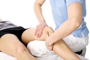 physical therapist working on a patients knee