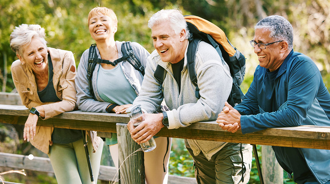 elderly friends taking a break during a hiking trip